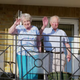 Lottie's grandparents smiling and waving from a balcony